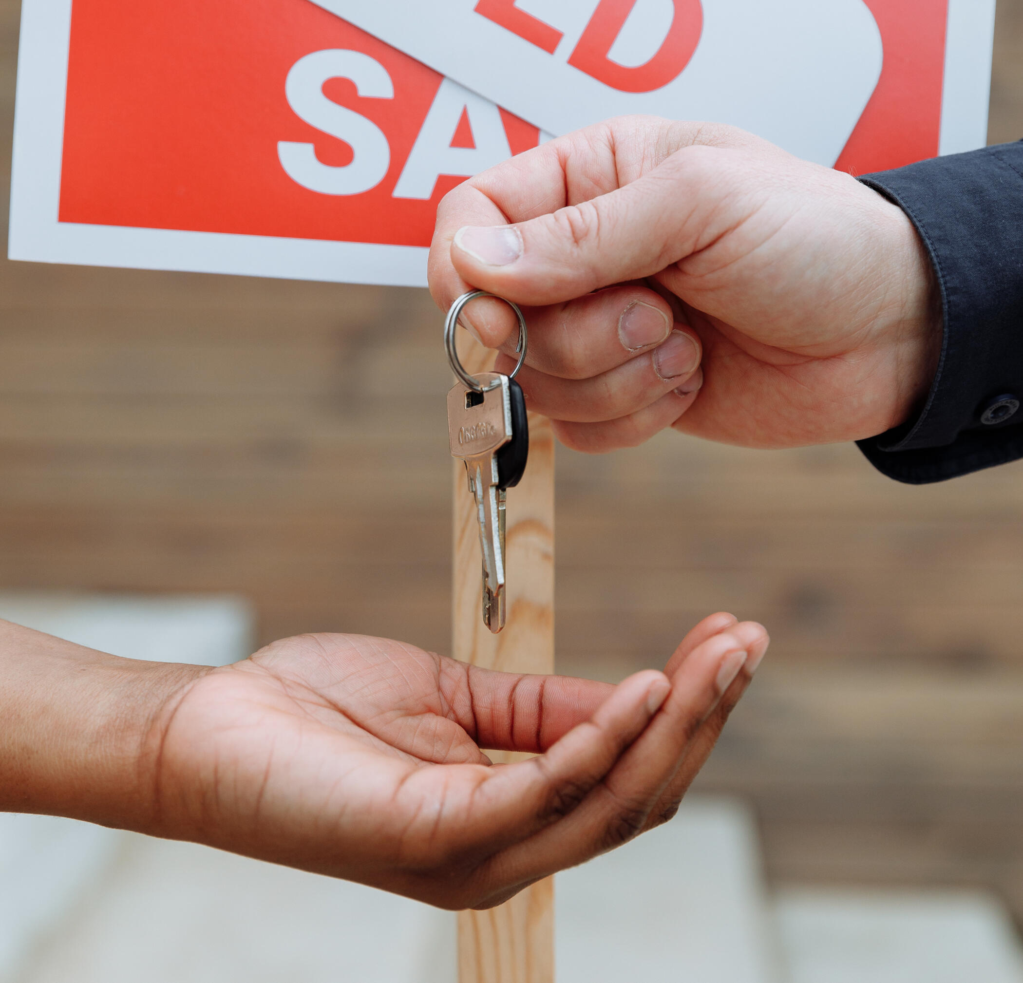 Photo of keys being given from one hand to another hand