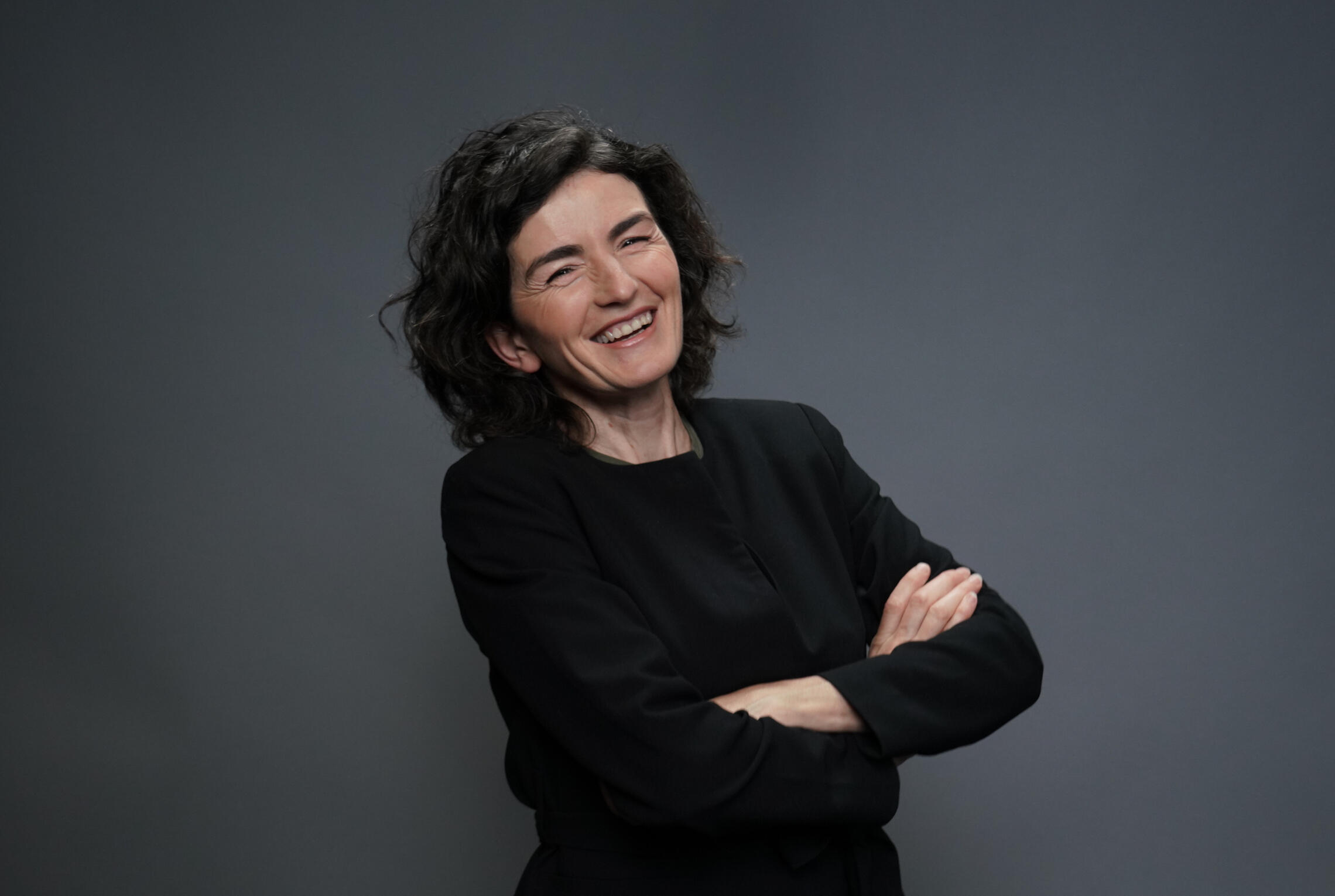 Dolores Stef portrait smiling and wearing a black suit