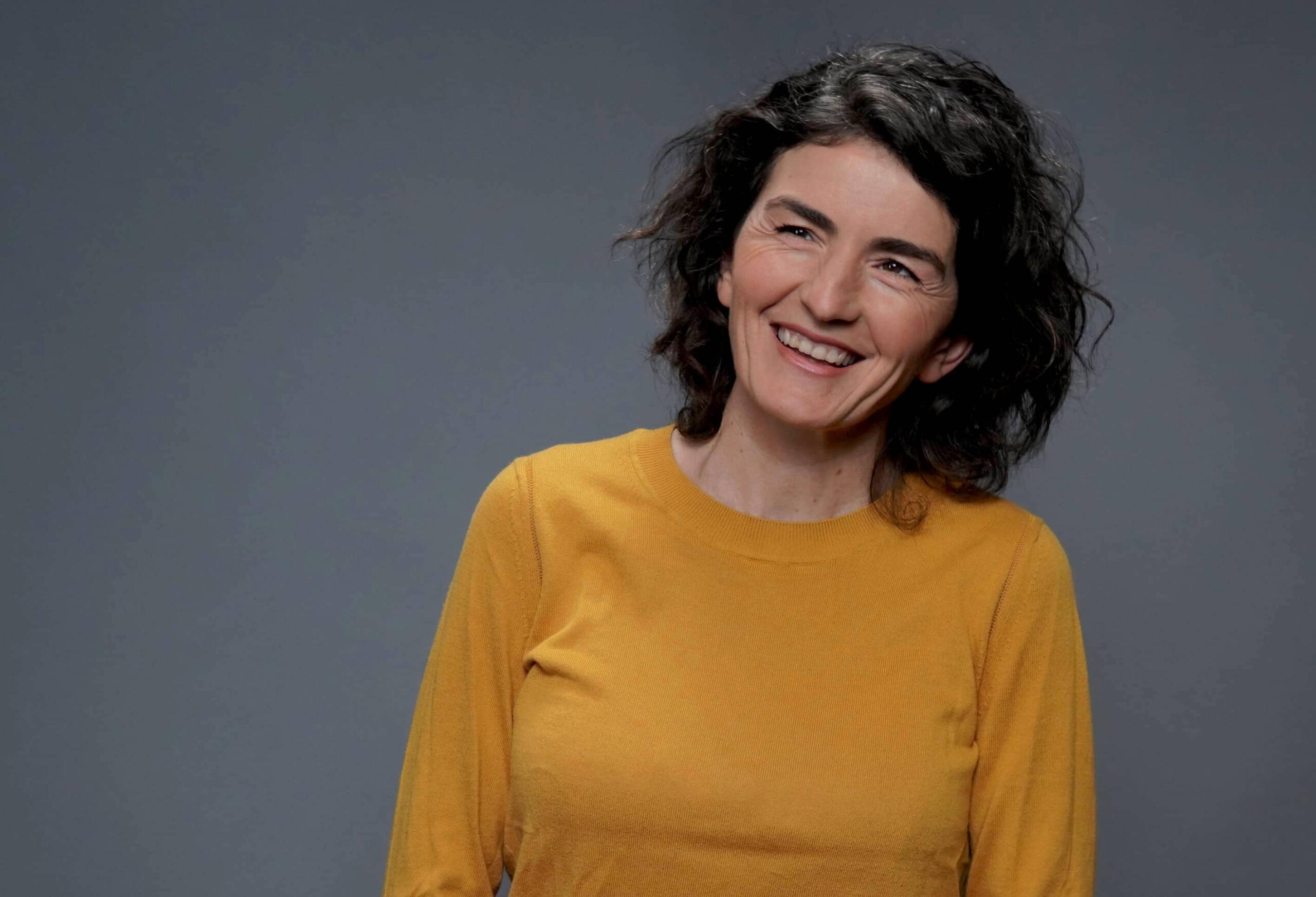 Dolores Stef portrait wearing a yellow sweater